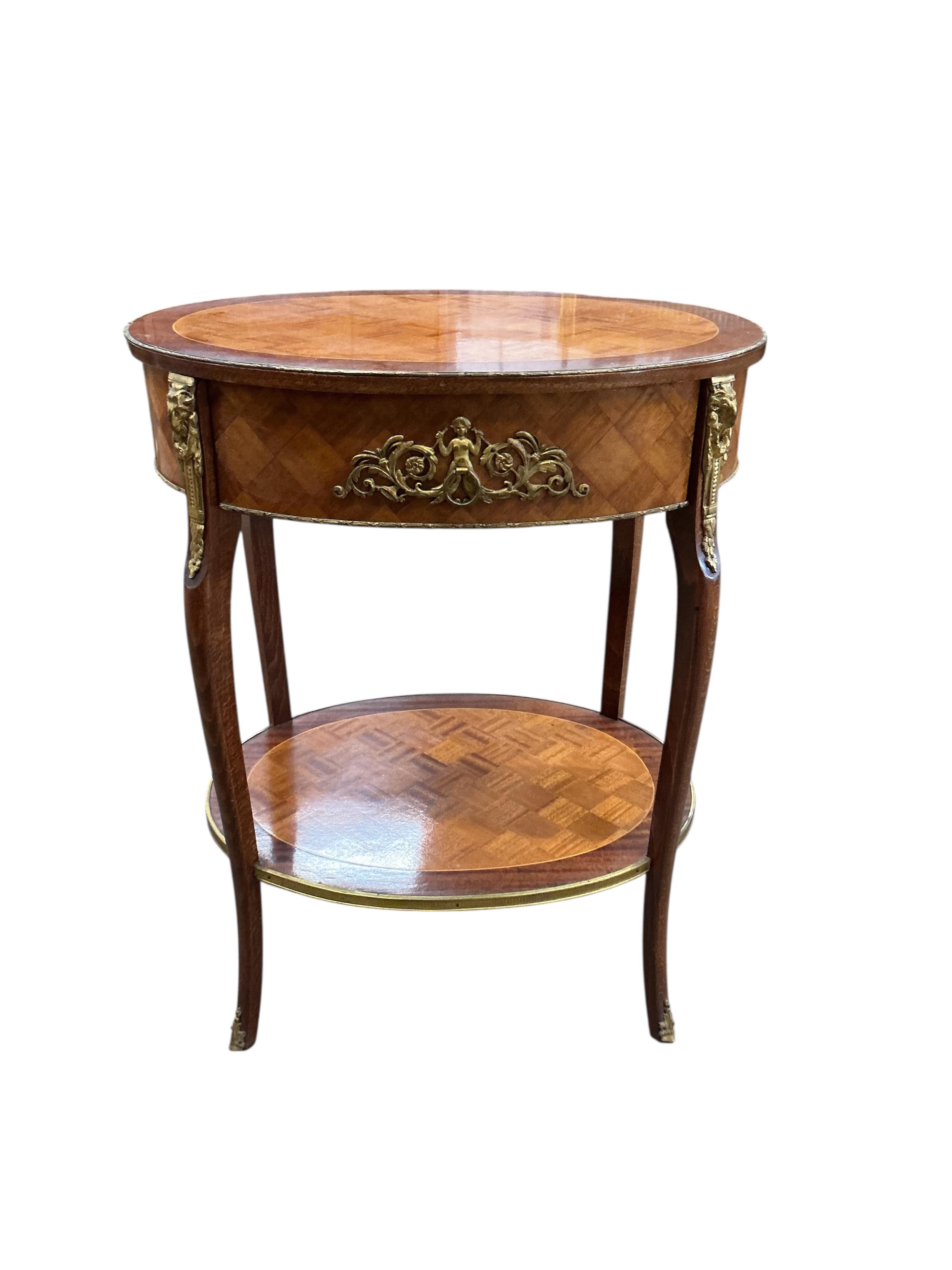 An early 20th century French transitional style gilt metal mounted satinwood parquetry and mahogany oval two tier table, width 53cm, depth 41cm, height 68cm